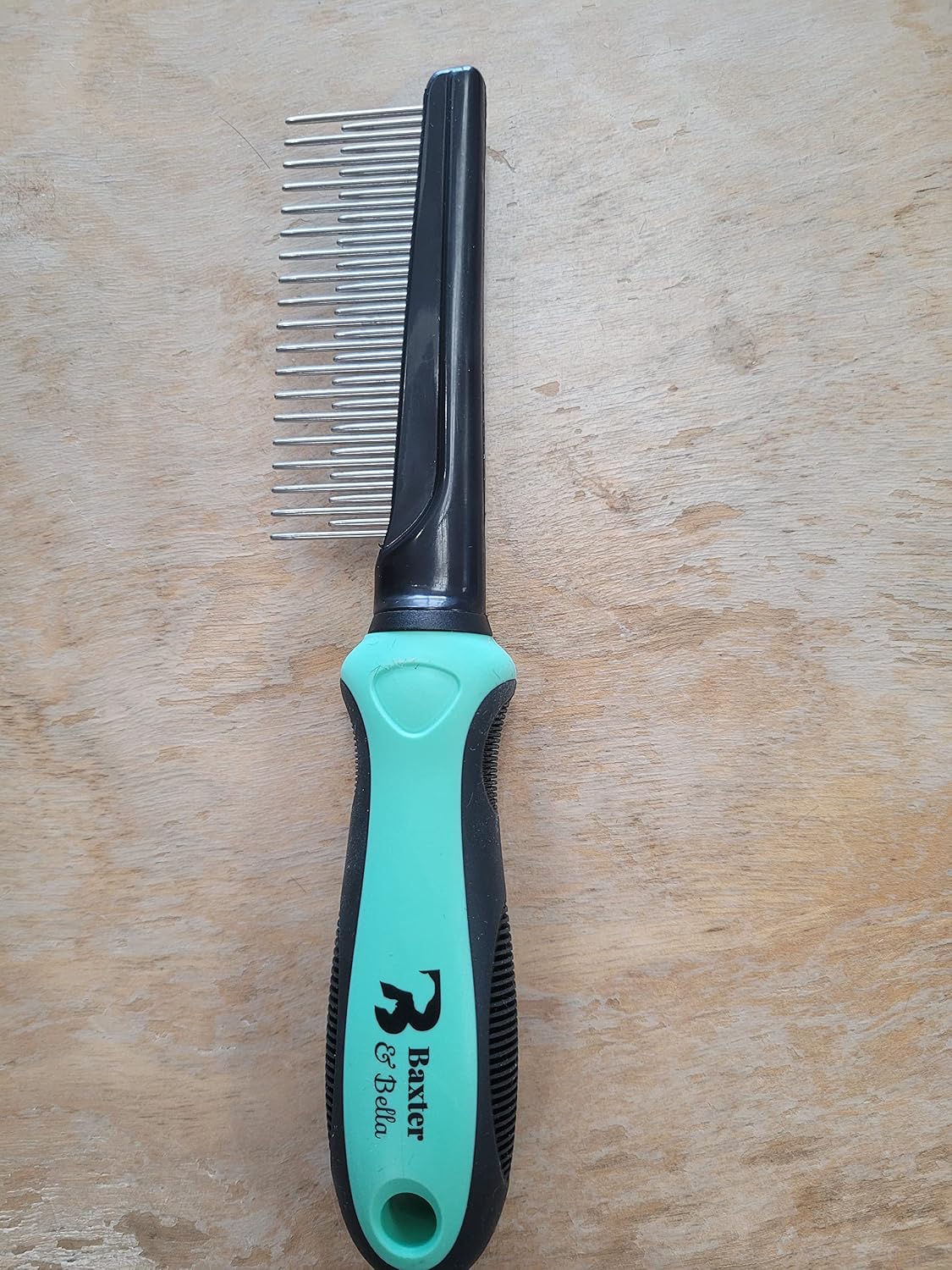 Close up of dual length metal teeth on pet shedding comb