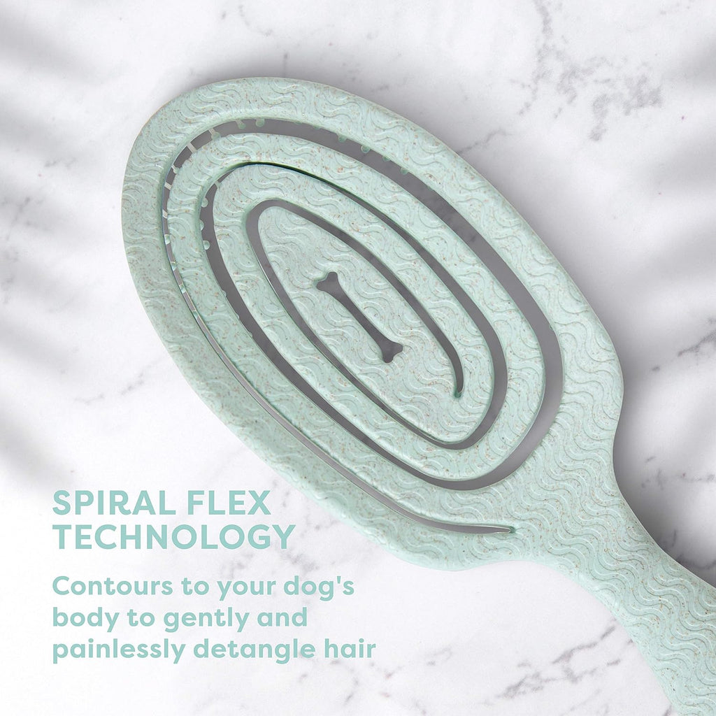 BioSilk eco friendly detangling dog brush placed next to pet grooming accessories.