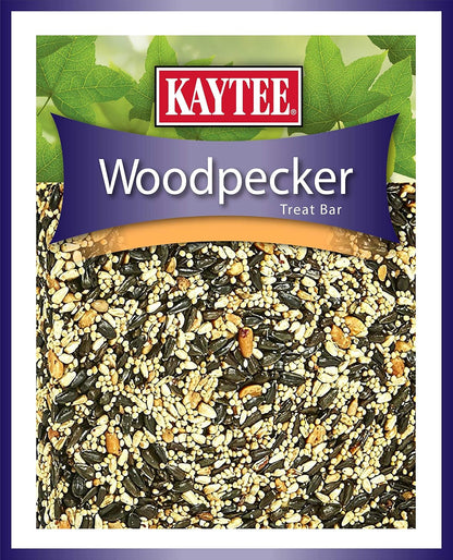Woodpecker feeding on a hanging Kaytee seed bar in a garden