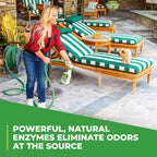 Enzymatic pet urine remover for artificial grass being applied with a garden hose attachment.