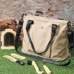 Side profile of the beige multi pocket storage tote bag packed with horse grooming supplies.