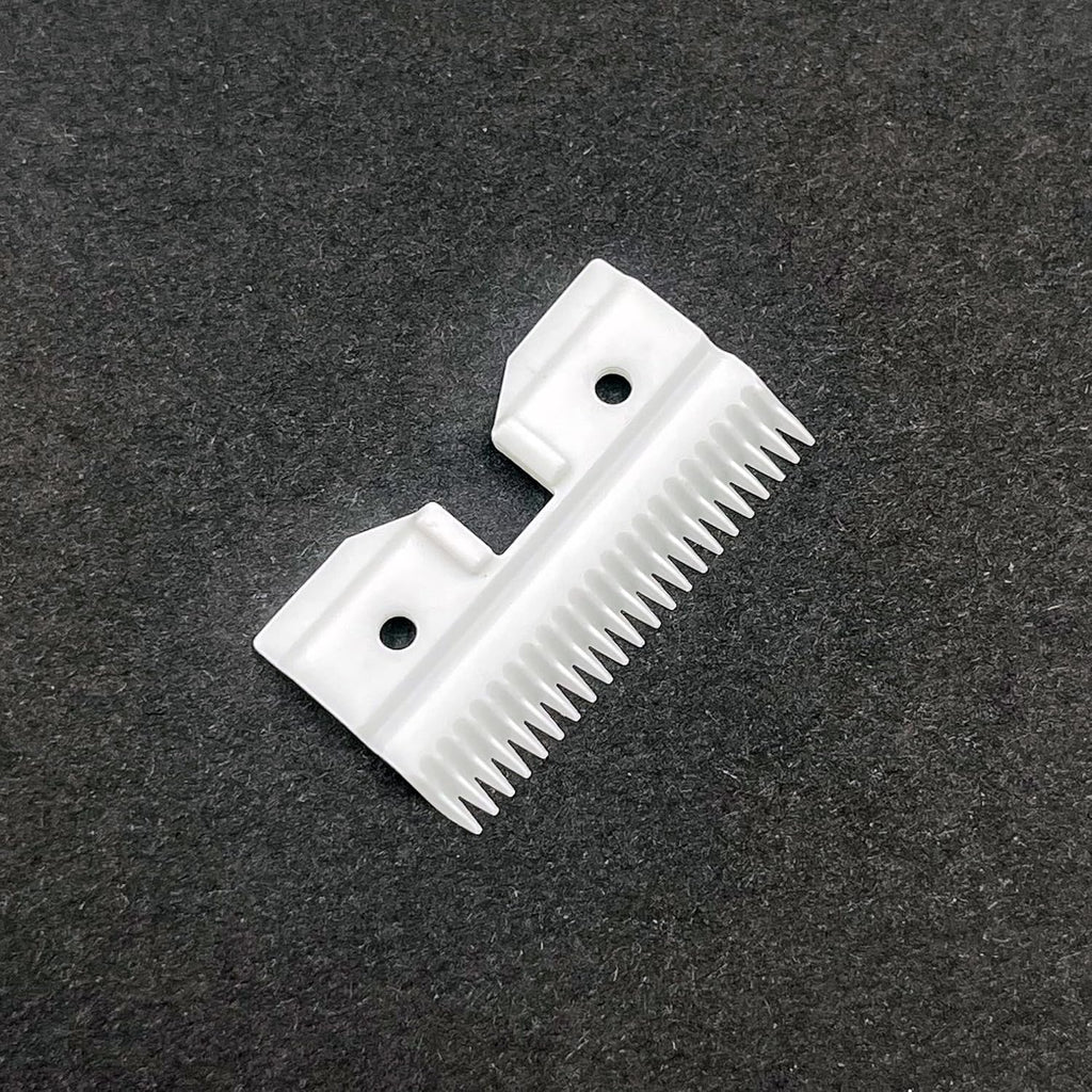 White ceramic pet clipper replacement blade parts on a clean backdrop