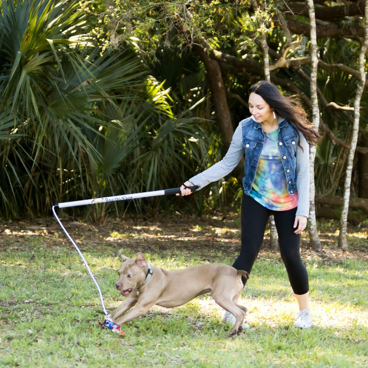 Durable interactive dog toy showing the soft non-slip grip handle and wrist strap close up.