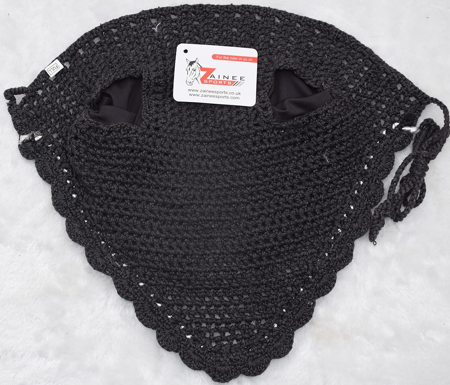 Equestrian horse ear bonnet secured under leather bridle