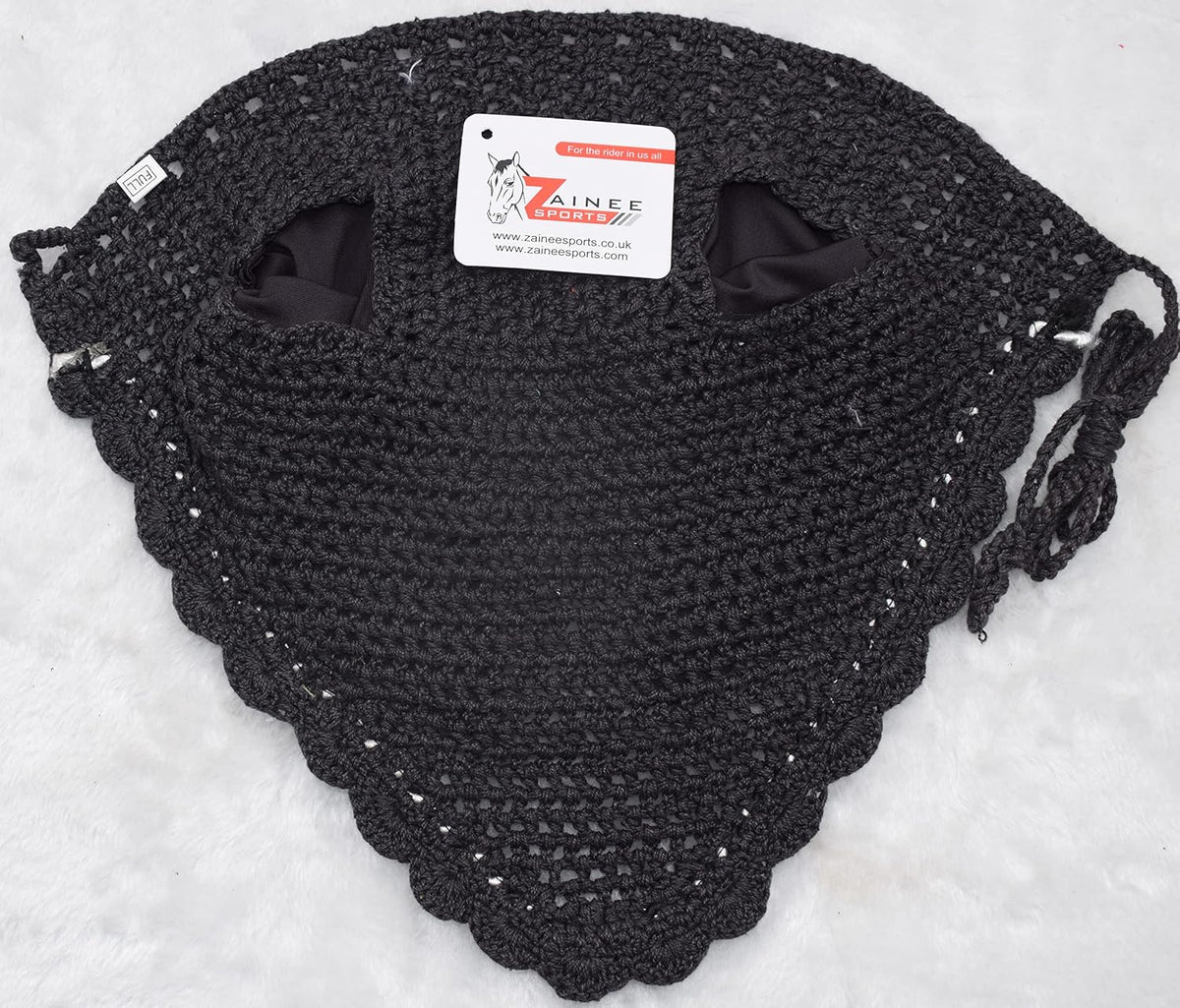 Equestrian horse ear bonnet secured under leather bridle