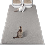 A domestic cat comfortably walking across the protective gray floor mat.