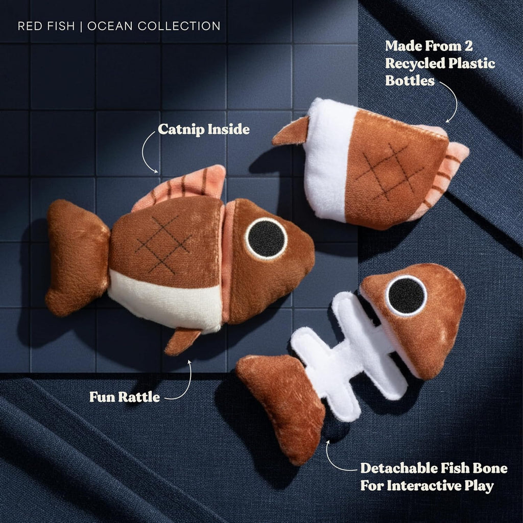 GRRREEN interactive stuffed animal fish puzzle toy being held to show the detachable fish bone piece.