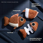 GRRREEN interactive stuffed animal fish puzzle toy being held to show the detachable fish bone piece.
