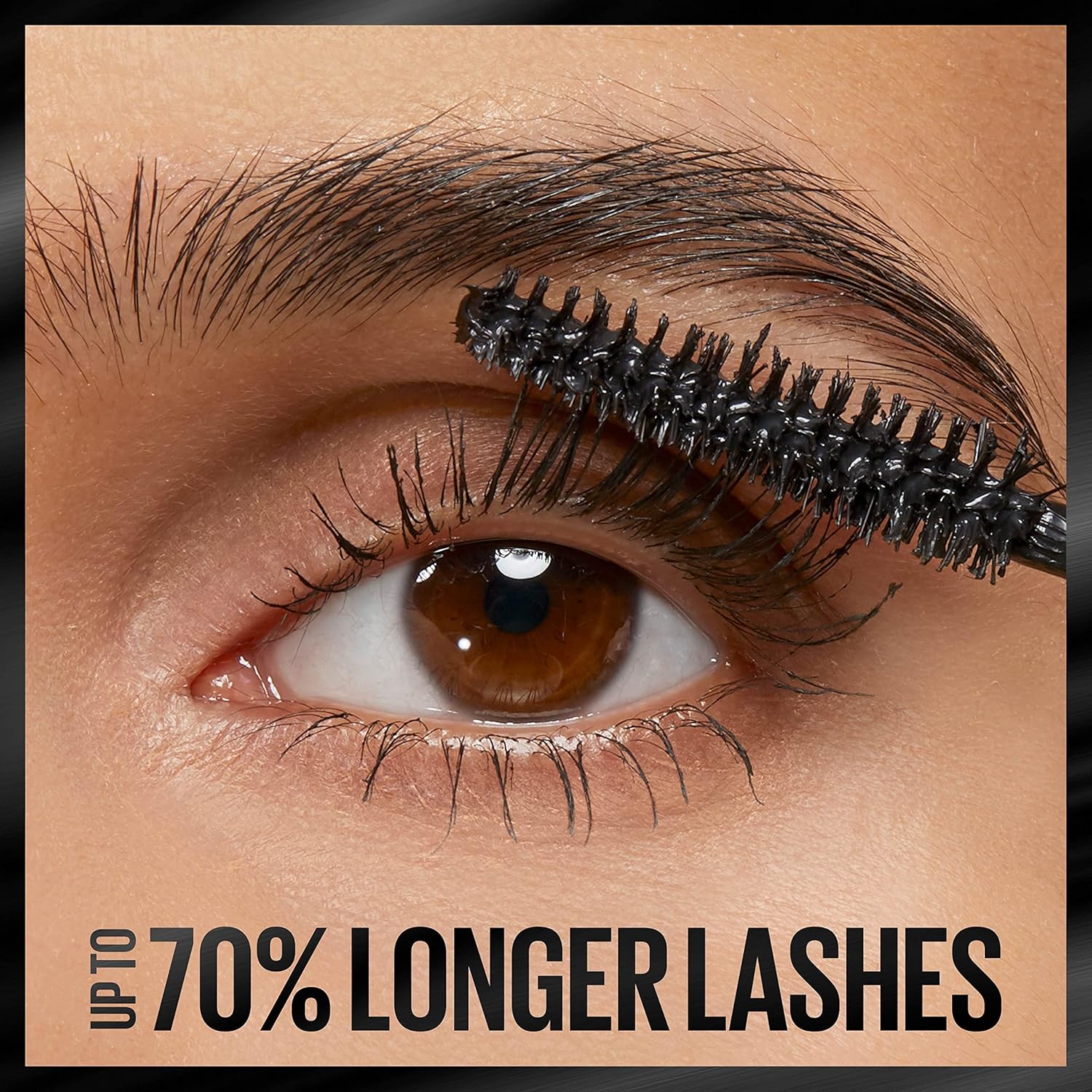 Maybelline lengthening mascara tube with the Grip and Extend brush wand pulled out to show the bristled applicator.
