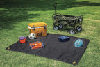 CAT premium utility blanket being used as an outdoor picnic mat on the grass.