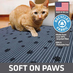 An extra large grey Drymate cat litter box mat laid out flat on a tiled floor.