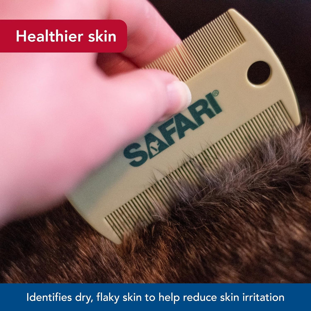 Hand holding Coastal Pet Safari flea comb demonstrating ergonomic grip