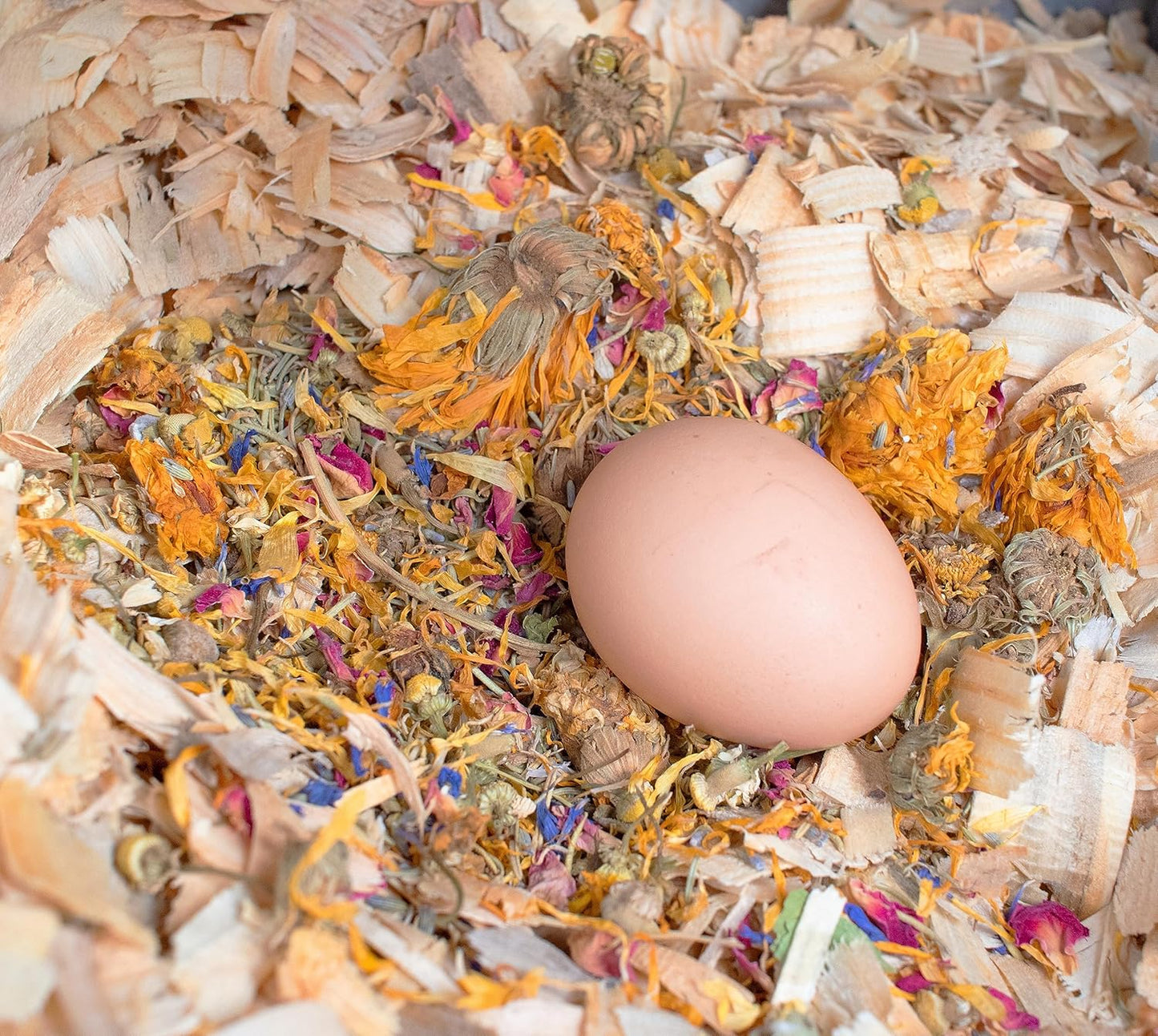 Pampered Chicken Mama nesting herbs sprinkled in a wooden nesting box