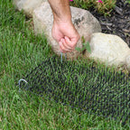 Cat deterrent mat placed inside a garden flower bed protecting plants