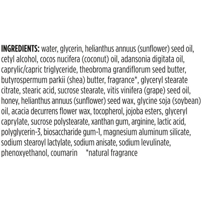 Burt's Bees Therapeutic Hand Cream placed next to raw honey and fresh grapes representing its key natural components.