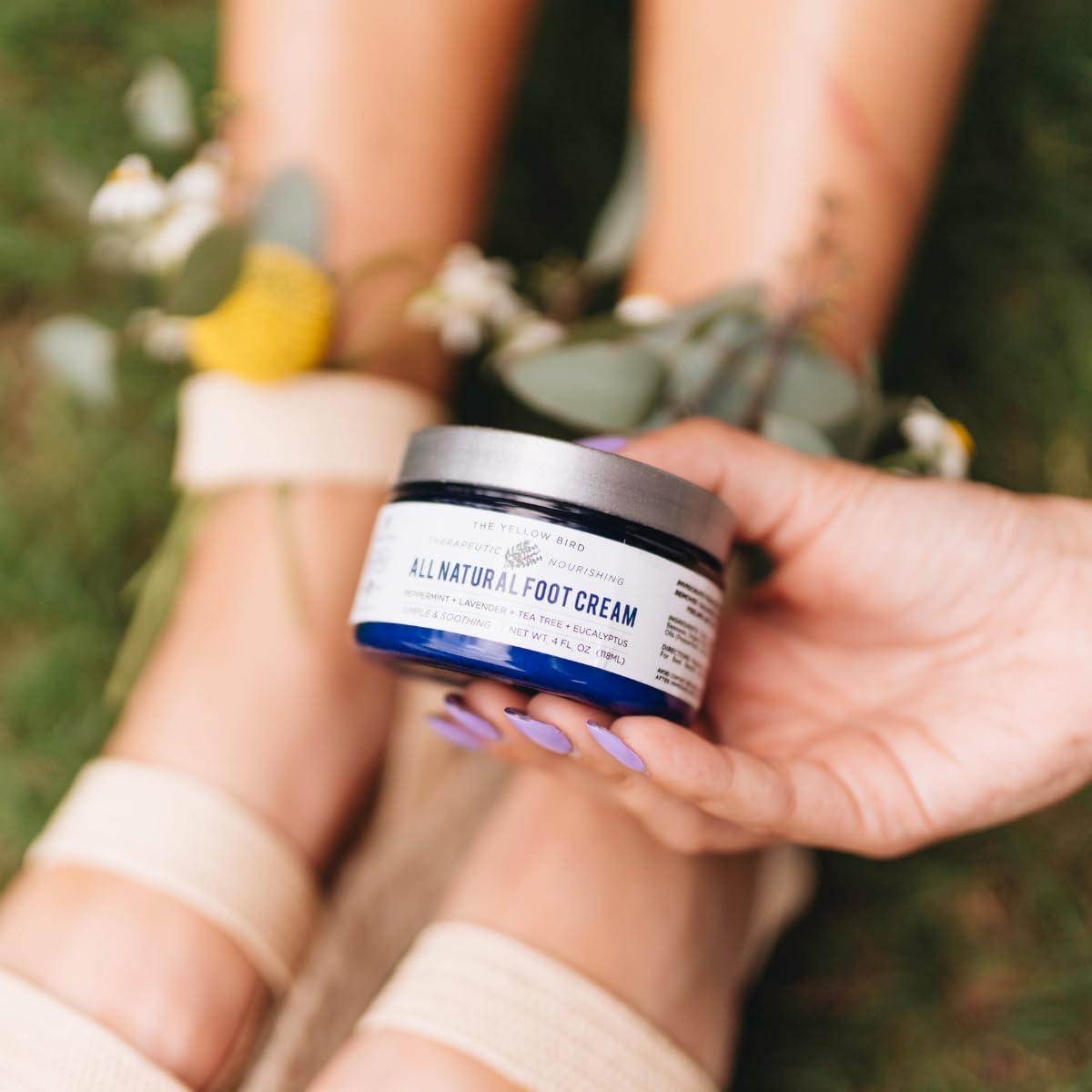 Lifestyle application shot of The Yellow Bird foot balm for dry heels.
