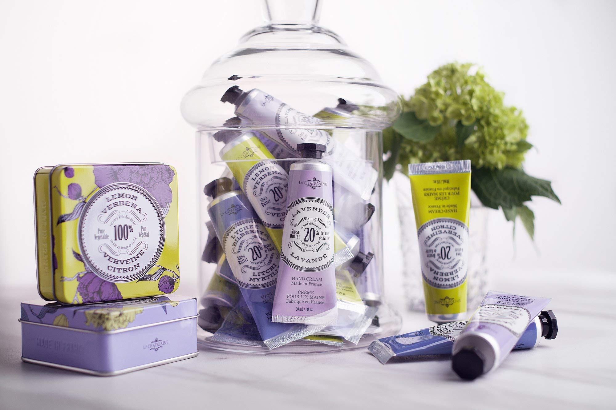 Compact purse sized La Chatelaine intensive moisture hand lotion tube being held to demonstrate the travel size