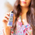 Hand holding La Chatelaine lavender moisturizing lotion