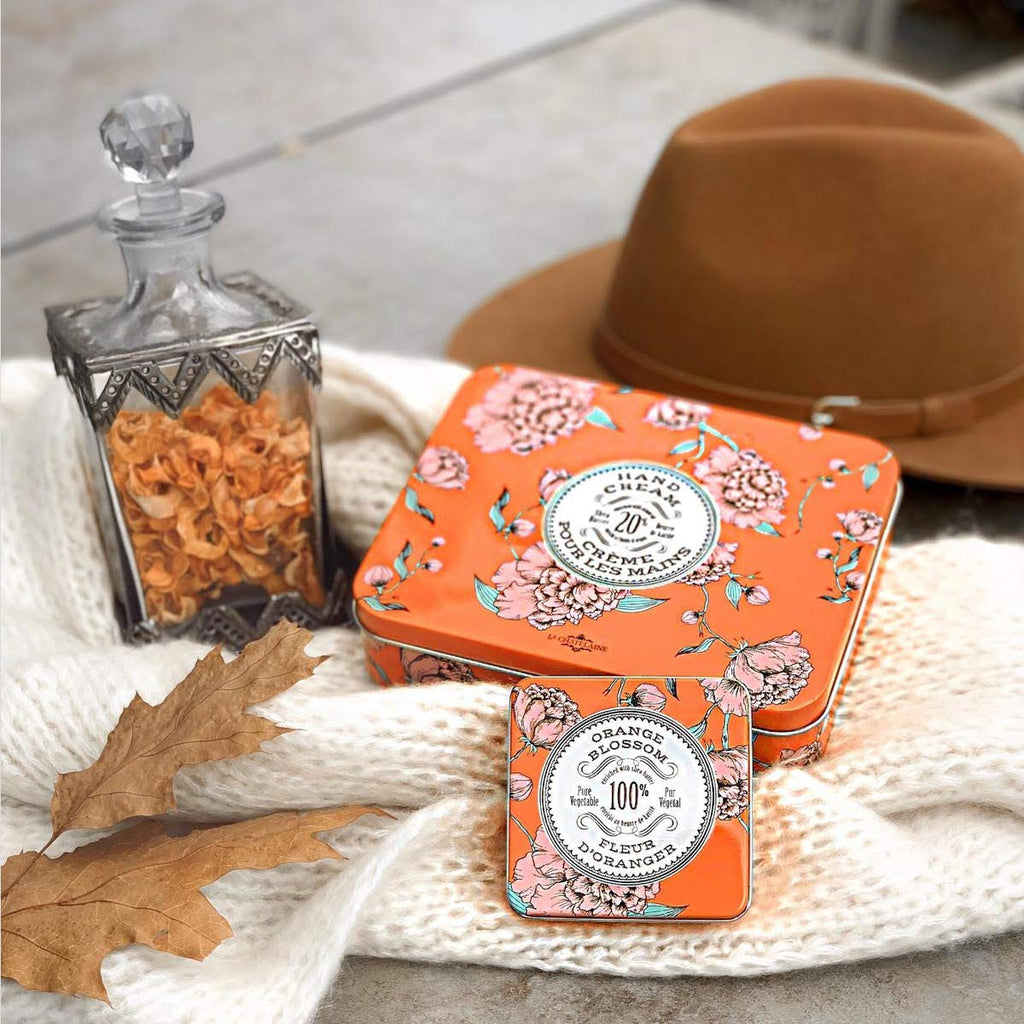 Lifestyle image of hand cream tubes being held or packed in a bag