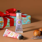 Yoken shea butter hand lotion tubes arranged outside the gift tin