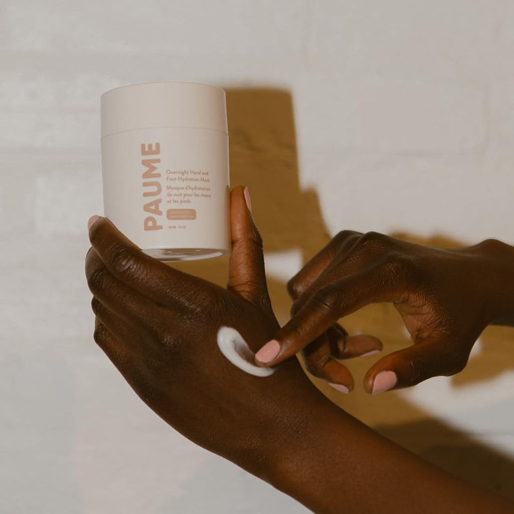 Person applying Paume hand mask before wearing overnight gloves