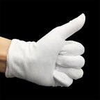Person wearing white moisturizing spa gloves on hands