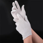 Stack of twelve pairs of white cotton gloves unfolded