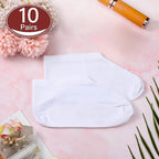 Ten pairs of white cosmetic foot care socks laid out flat