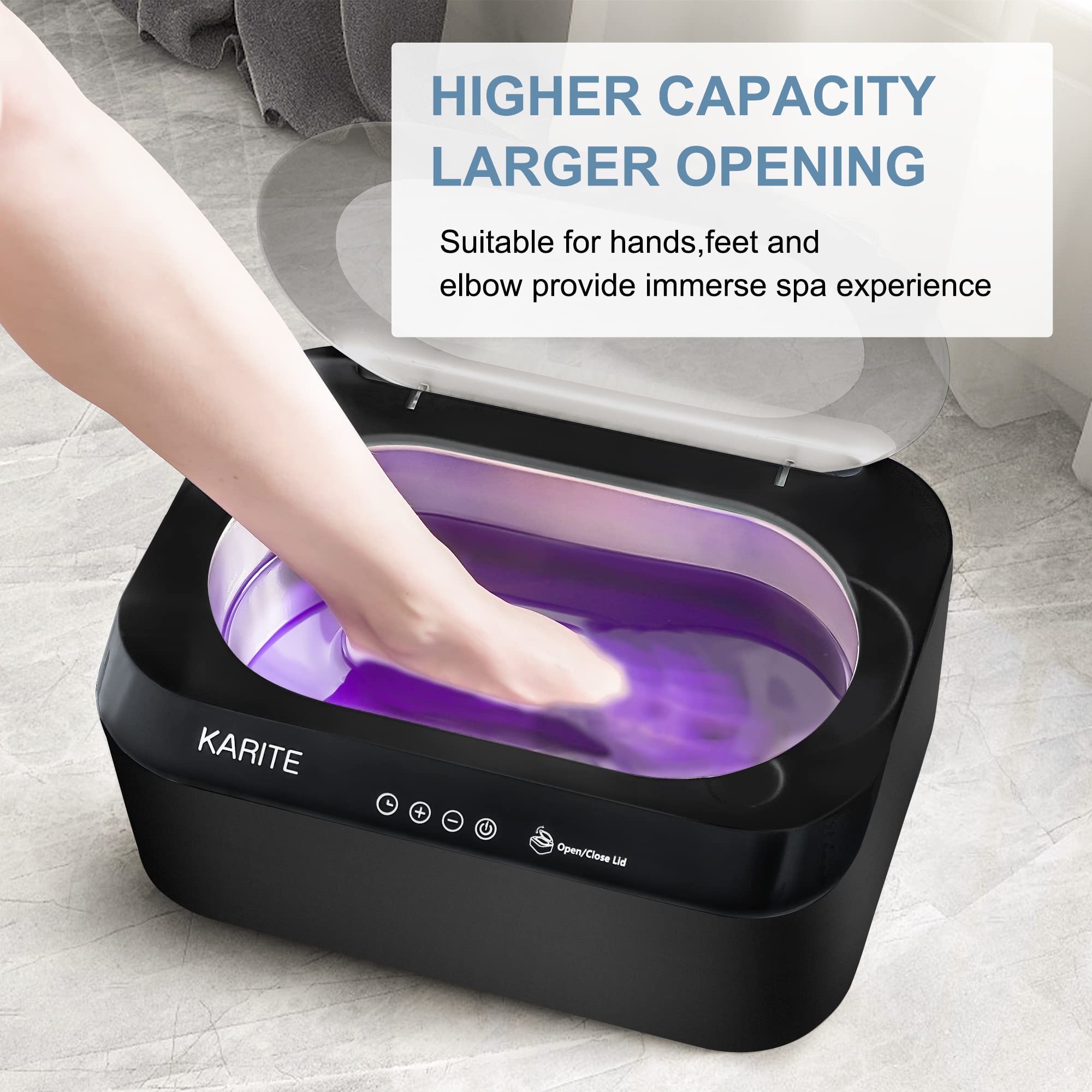 User safely dipping a hand into the warm liquid wax inside the Karite therapeutic machine.