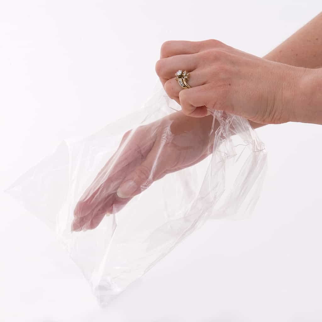Foot insertion into large clear plastic liner for deep hydration therapy