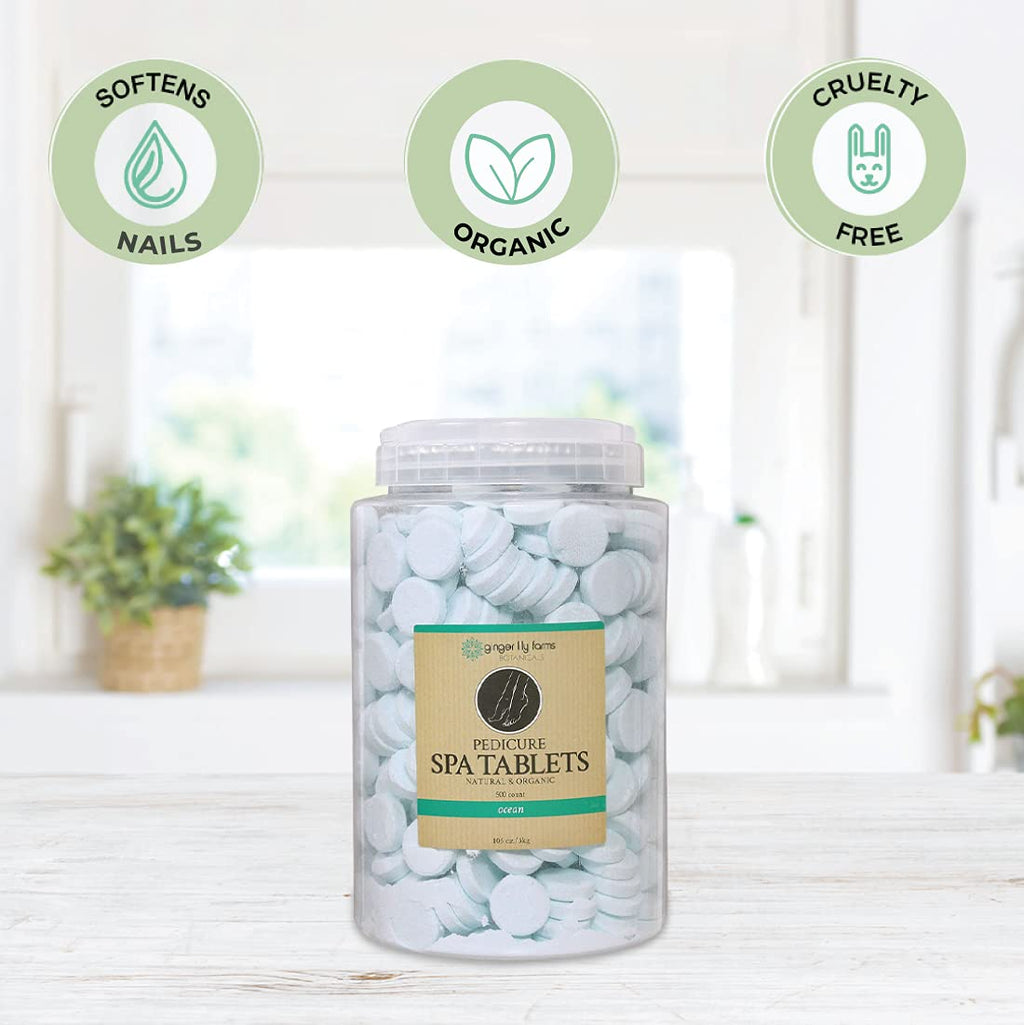 Effervescent pedicure spa tablets dissolving in warm water foot bath