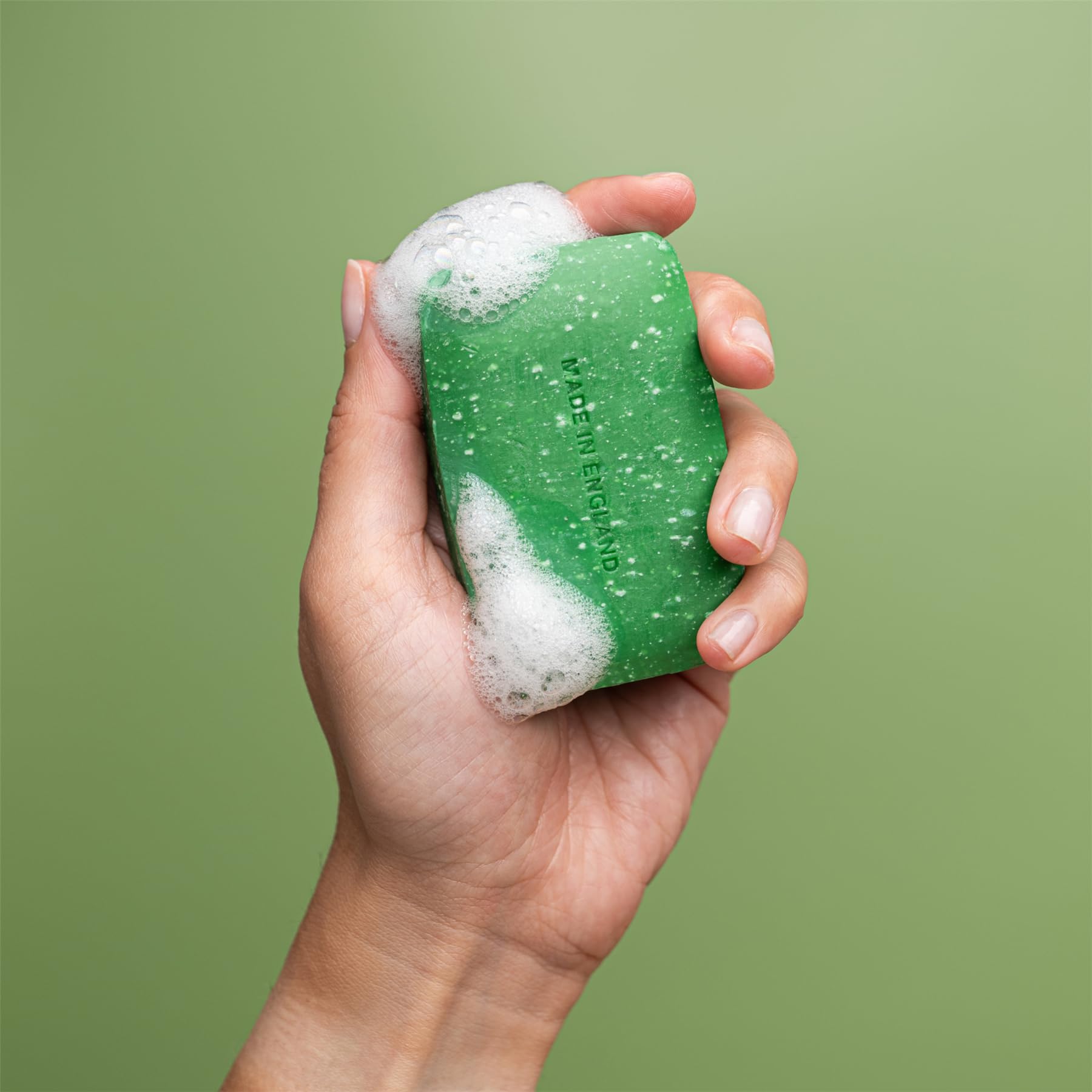 Close-up view of the natural pumice exfoliating particles inside the REVITALE foot scrub treatment