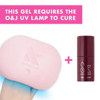 Olive and June gel nail polish bottle displayed next to LED curing lamp