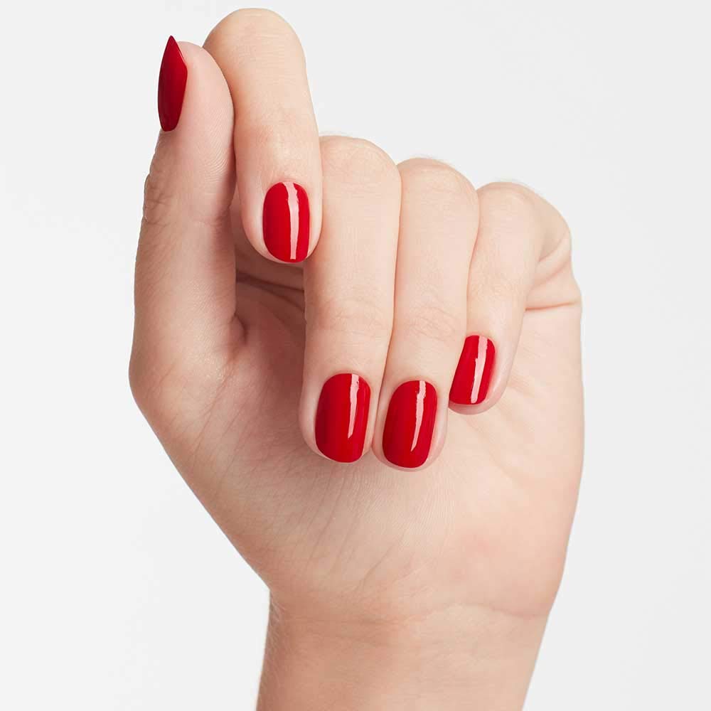Professional manicure showing OPI Big Apple Red shade