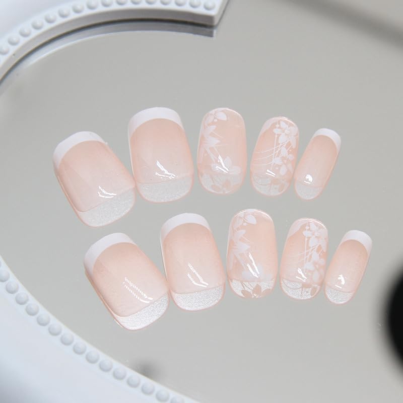 Model wearing short coffin French tip floral artificial nails