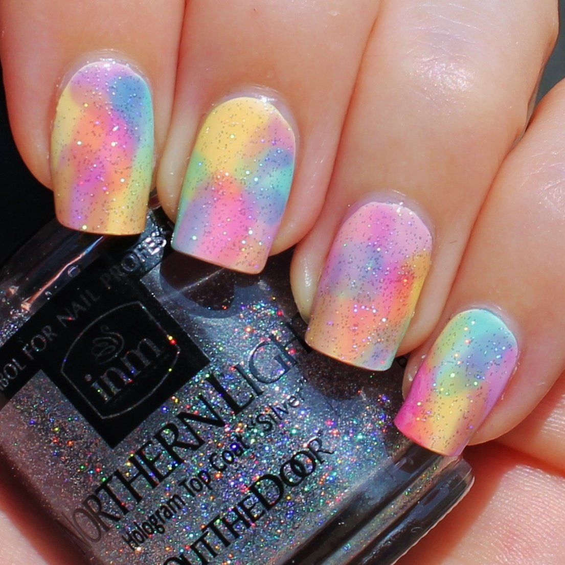 INM fast drying holographic top coat showcasing the brush applicator and smooth fluid texture