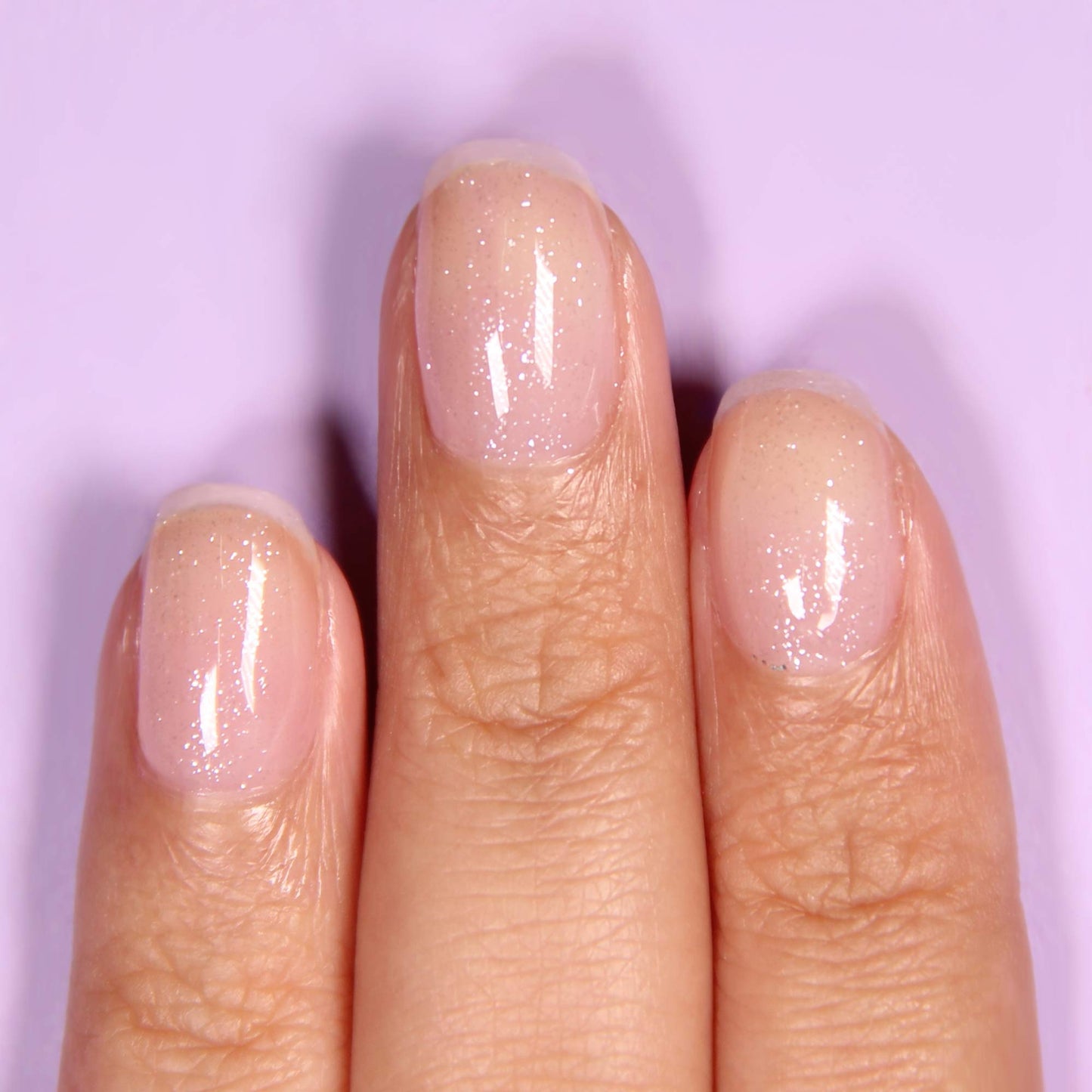LONDONTOWN shimmering iridescent nail polish top coat bottle displaying the clean vegan ingredients label