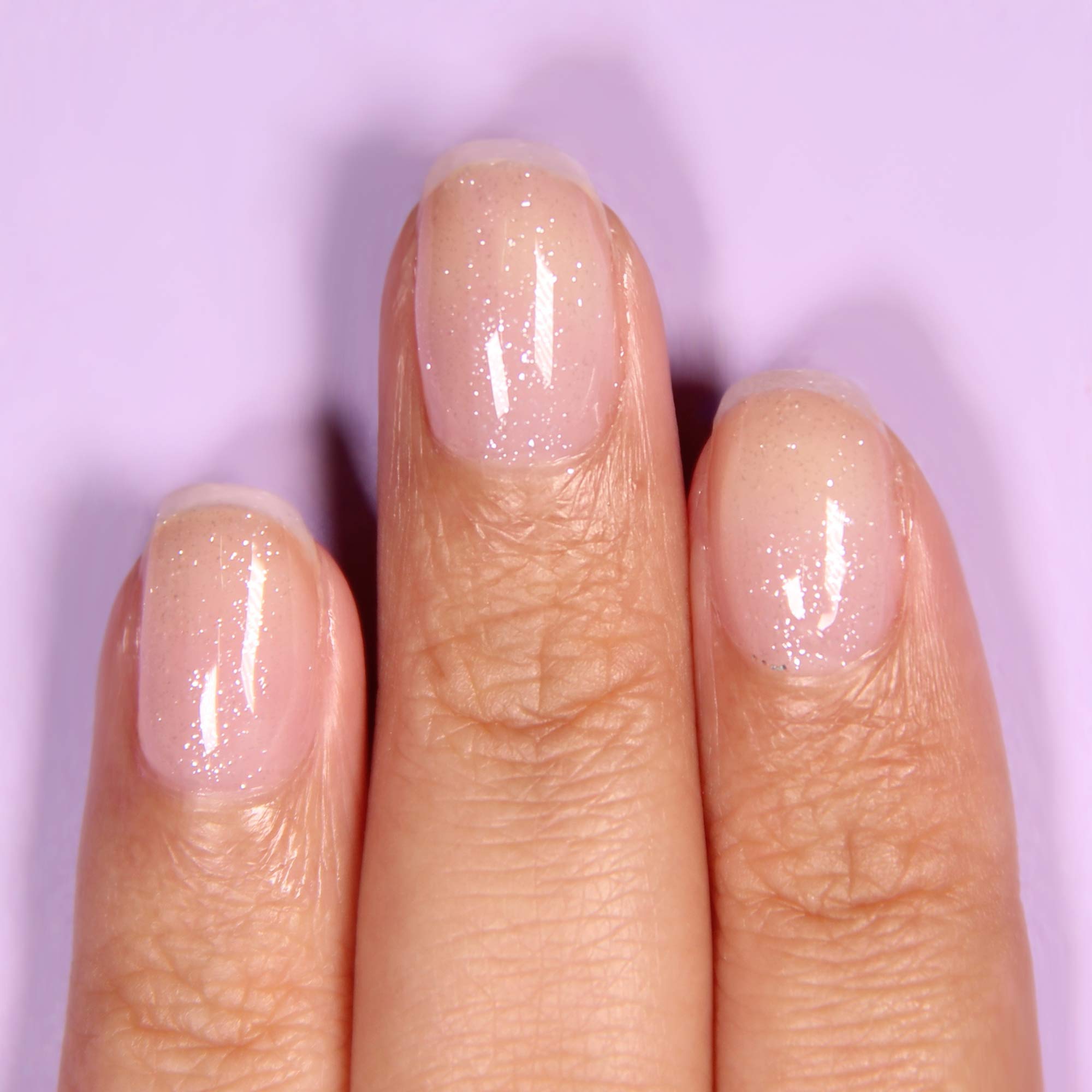 LONDONTOWN shimmering iridescent nail polish top coat bottle displaying the clean vegan ingredients label
