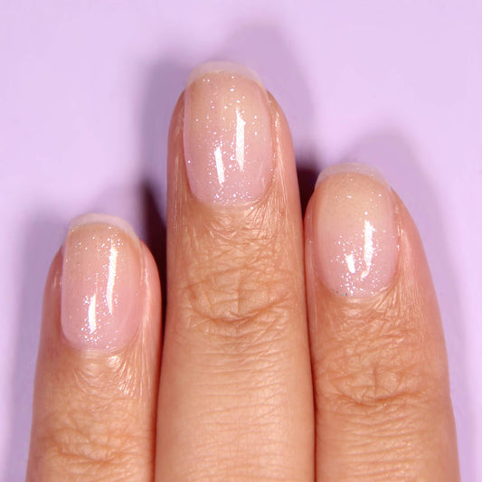 LONDONTOWN shimmering iridescent nail polish top coat bottle displaying the clean vegan ingredients label