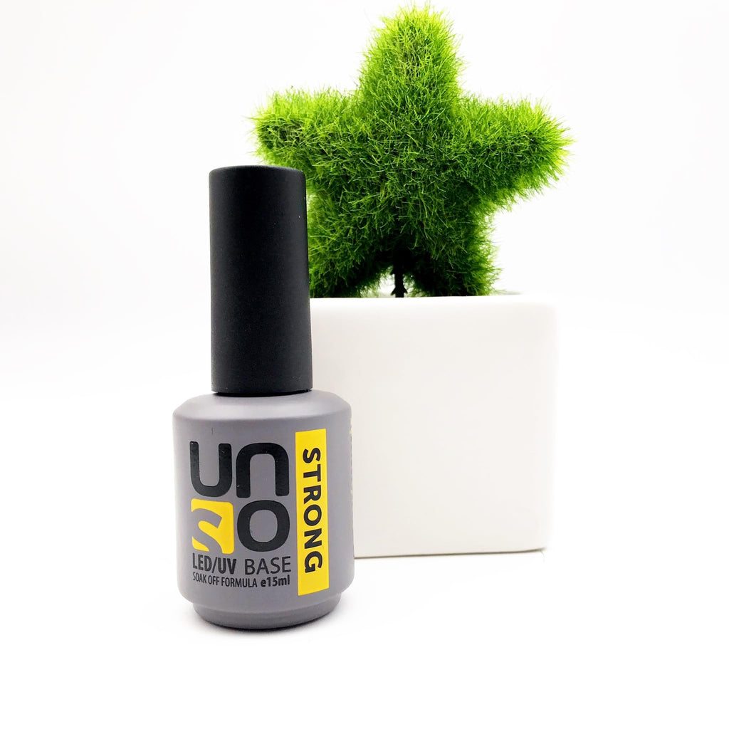 Gel nail polish bottle beside application brush