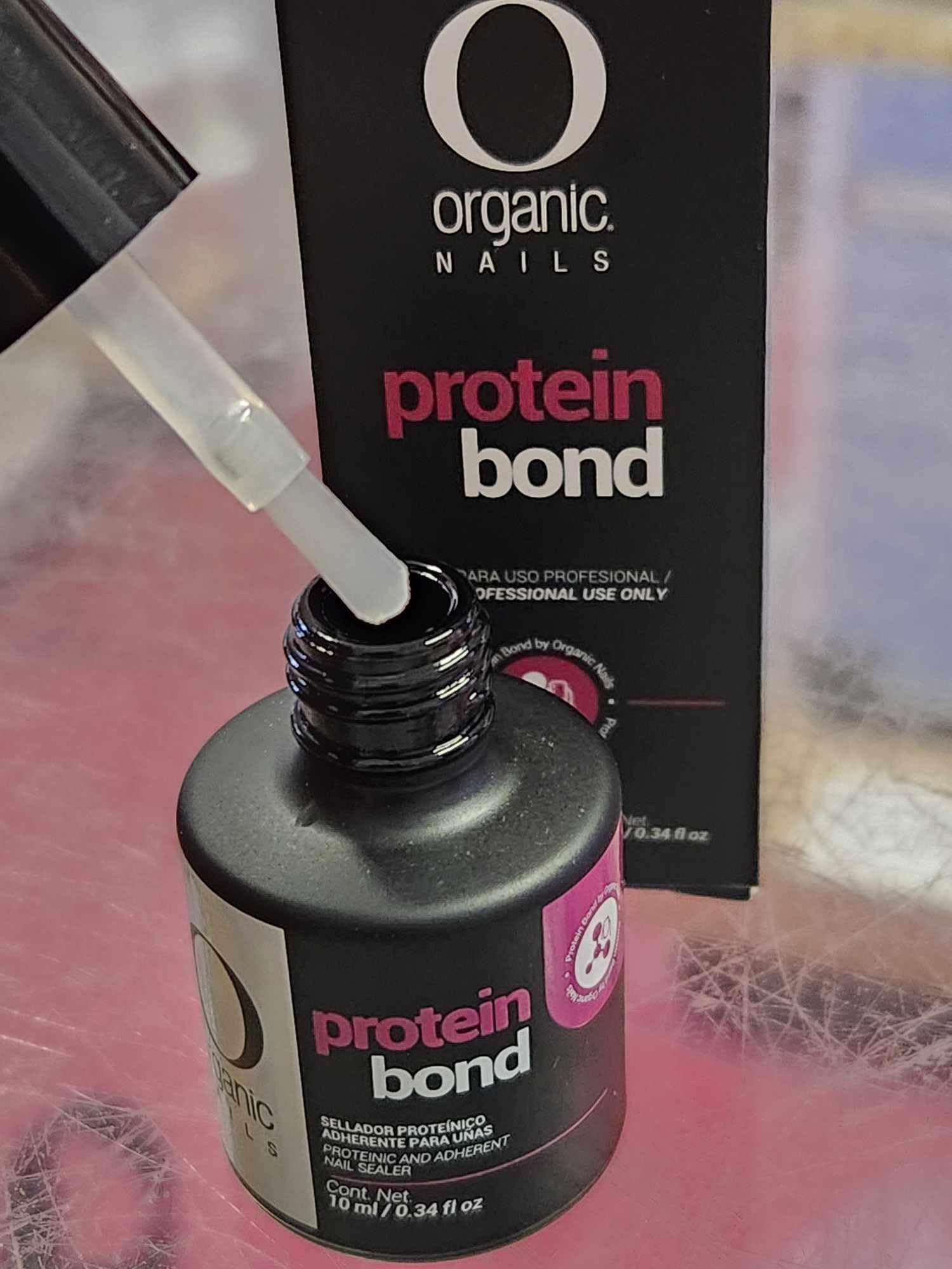 Professional grade salon manicure preparation bonding agent bottle close up view