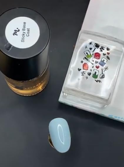 Maniology reverse stamping base coat bottle opened showing the applicator brush designed for smooth lightweight layer distribution