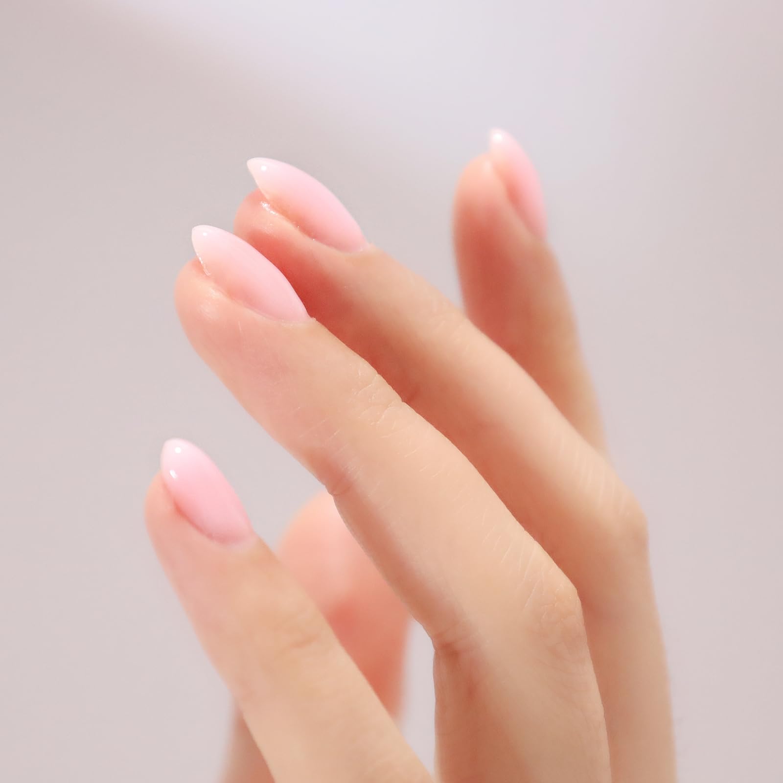 Thick self-leveling texture of the sheer red rubber builder gel being applied to a natural nail plate.