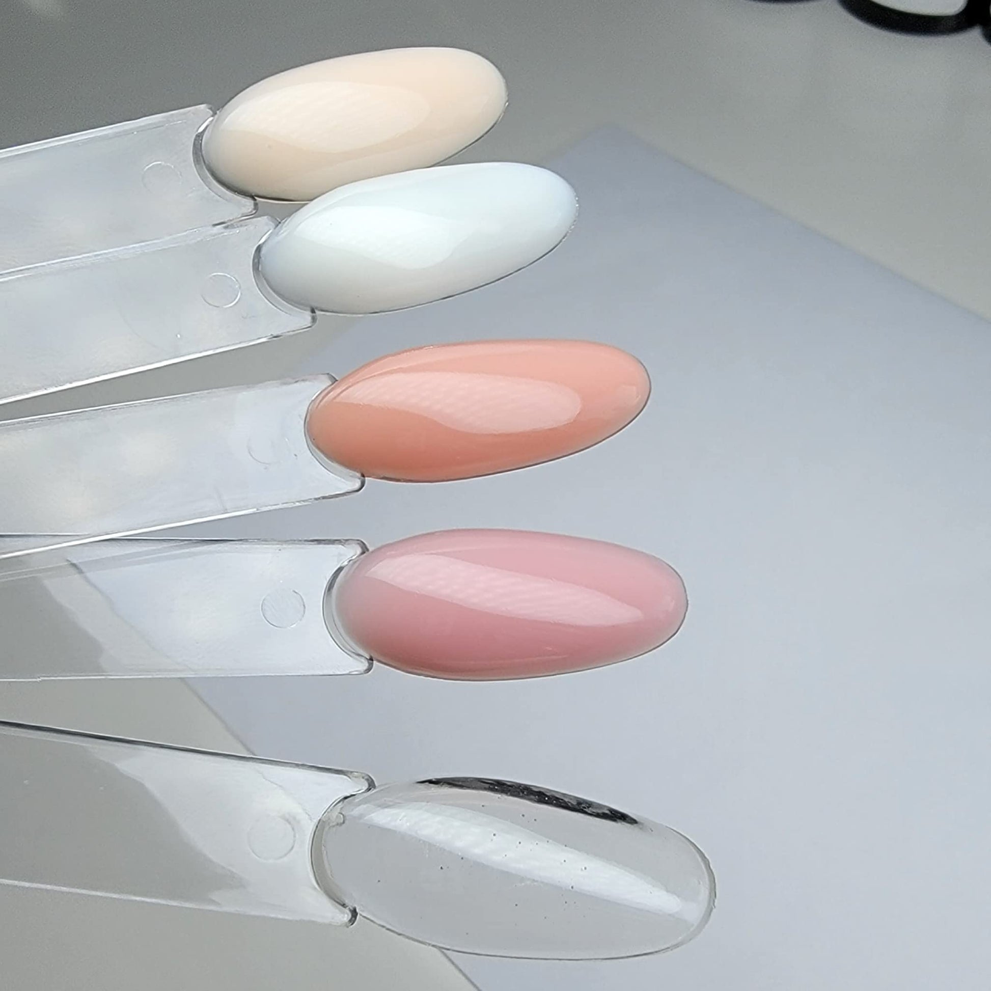 Dan's Nails professional high adhesion gel base layer bottle highlighting chip resistant nail protection properties.