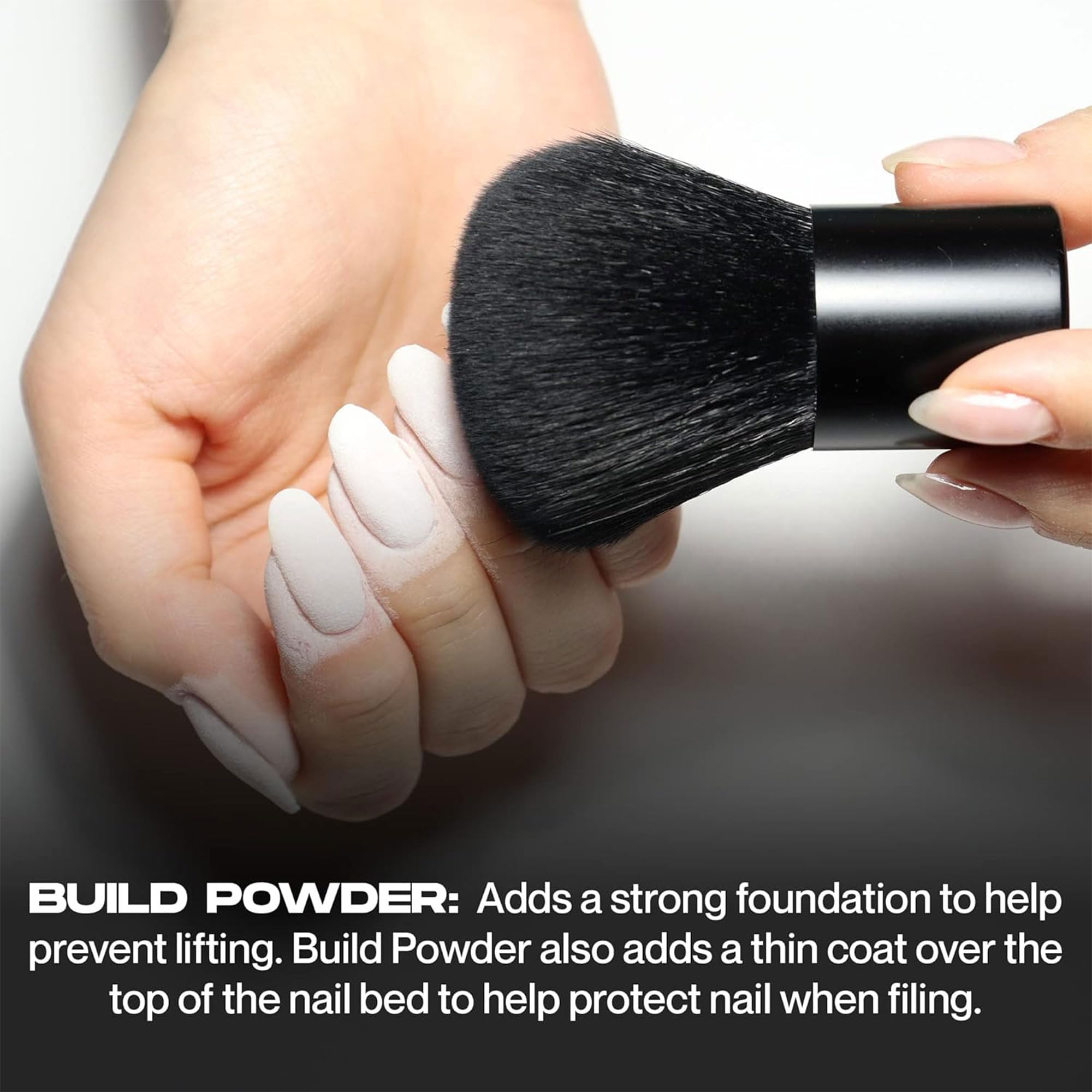 Hand applying Nailboo dip powder at home