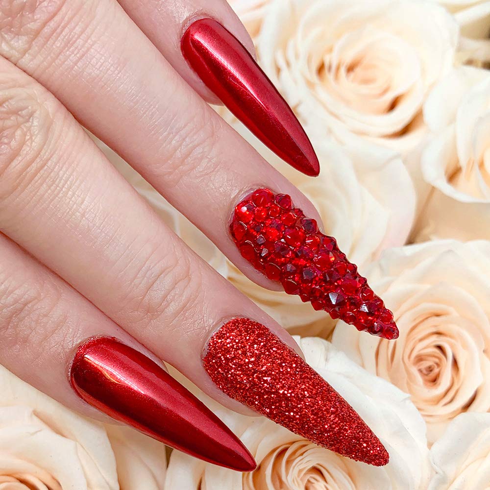 Professional nail technician applying red chrome pigment
