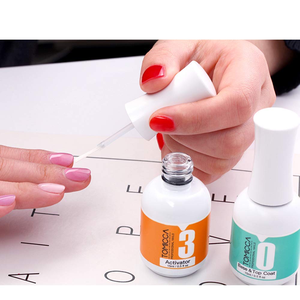 Close up of TOMICCA activator and base coat bottles highlighting the application brushes