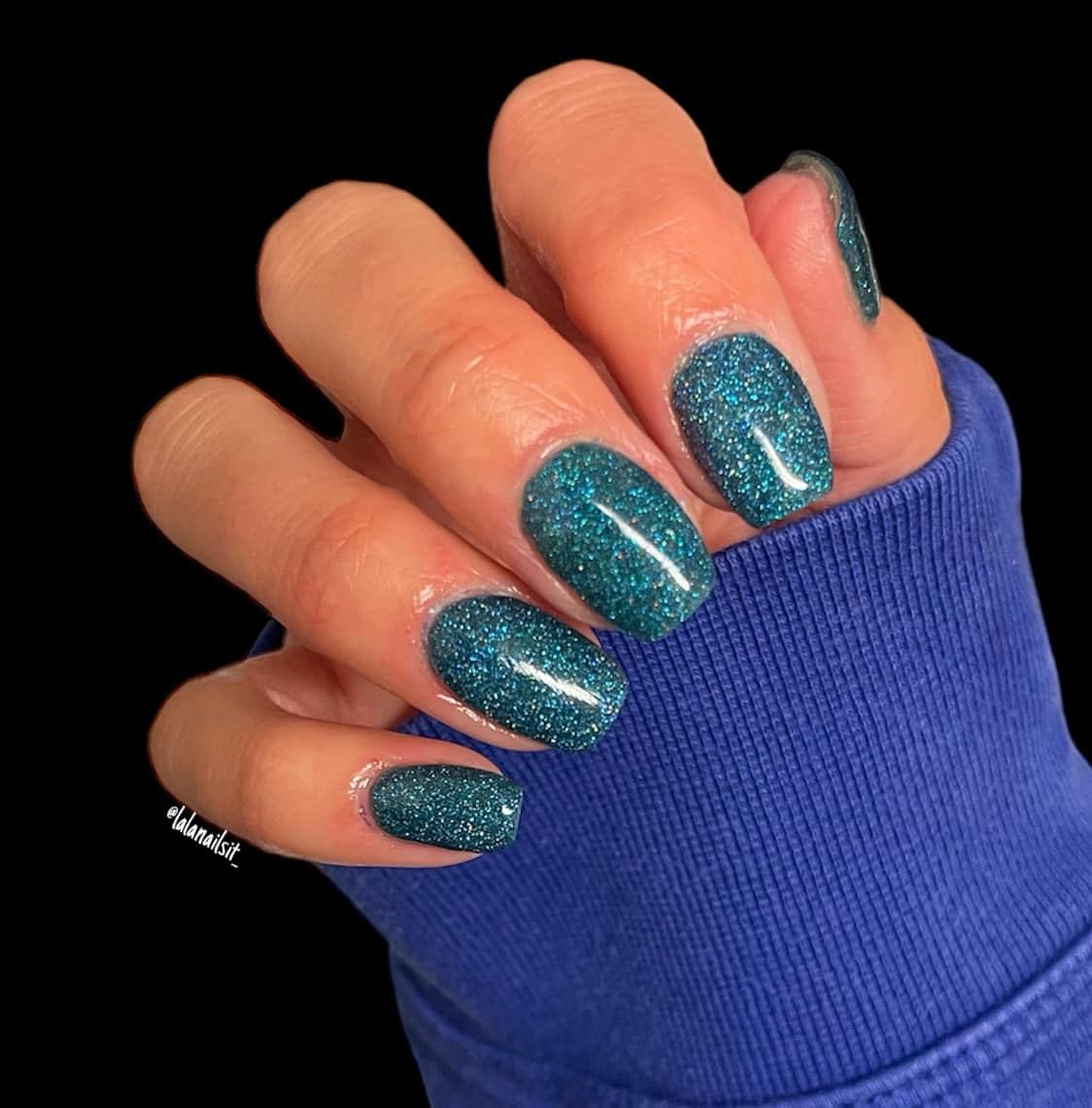 Glossy top coat nail lacquer bottle close up illustrating the professional non toxic formula.