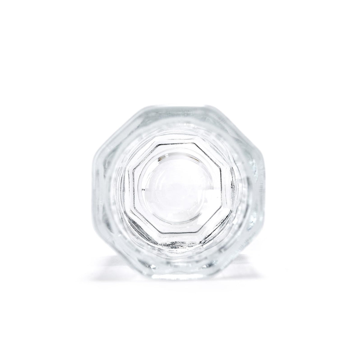 Perspective view of the compact glass dappen dish resting on a nail station.