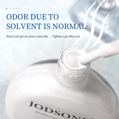 High fluidity white blooming gel polish being applied with a brush onto an uncured nail layer